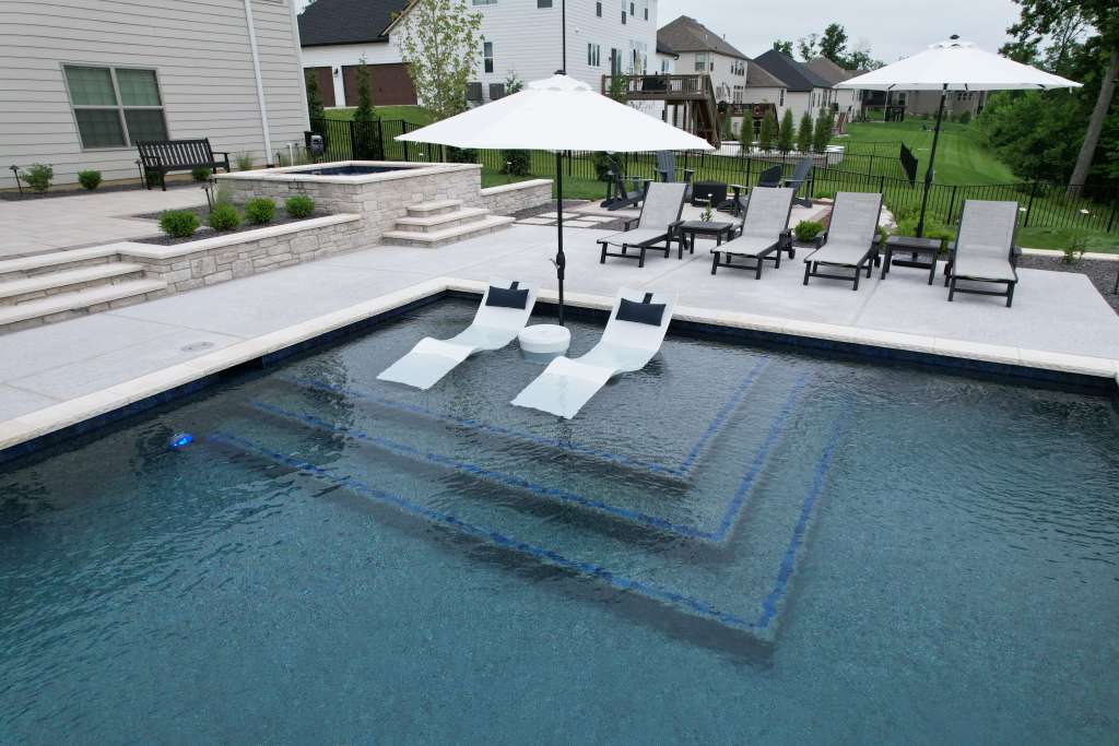 Pool with tanning chairs and umbrella